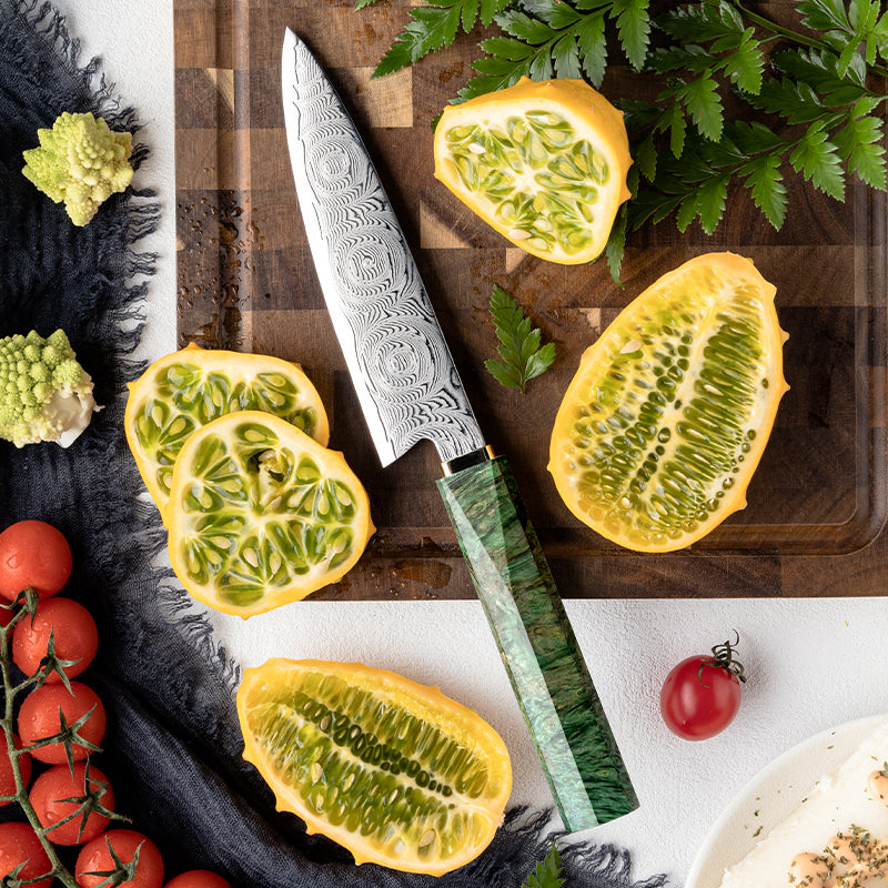 Knife on a wooden cutting board with sliced yellow fruit and tomatoes. Decorative Rose Damascus Pattern knife