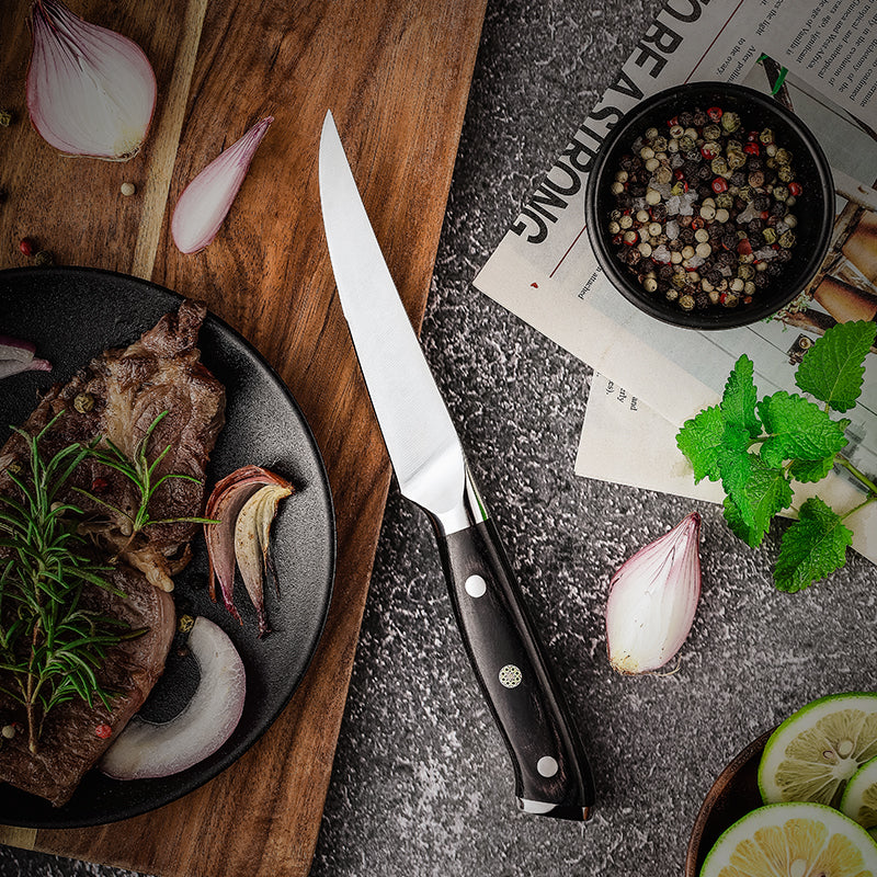 Steak Knife branded 'hikari knife' on a wooden cutting board with cooked meat, onions, and herbs on a gray surface.