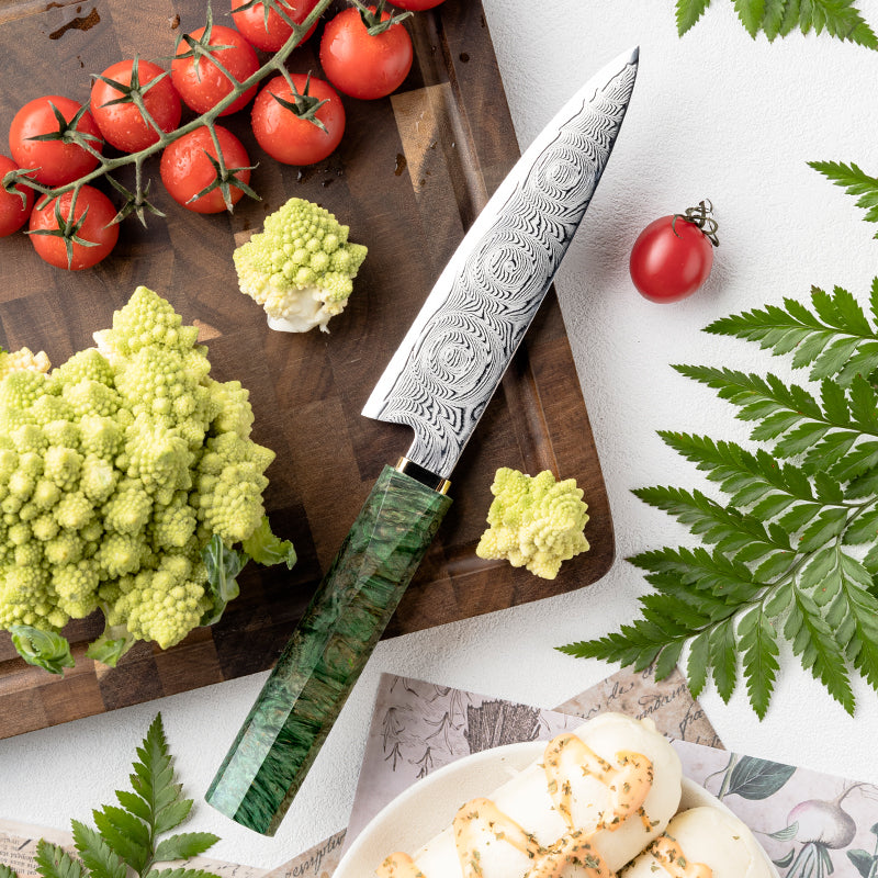Decorative Rose Damascus Pattern knife  on a cutting board with vegetables and tomatoes