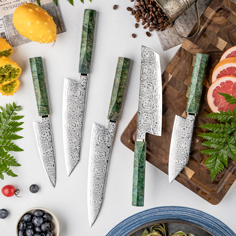 Set of knives with green handles on a table with fruits and a cutting board.