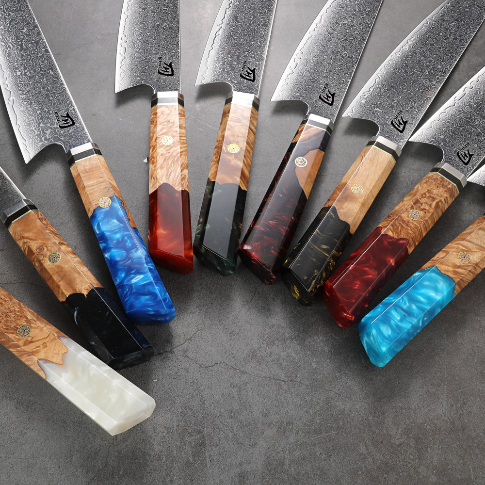 Set of knives with various colored handles on a gray surface
