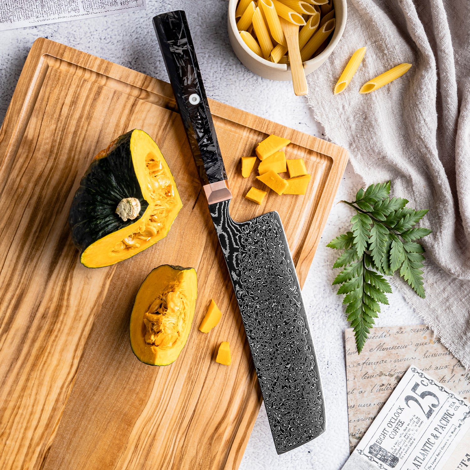nakiri vegetable knife Knife with decorative handle on a cutting board with sliced squash and pasta.